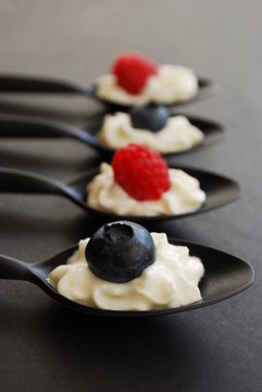 Blueberries and raspberries with whipped cream