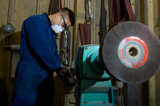 Polishing Metal In Workshop