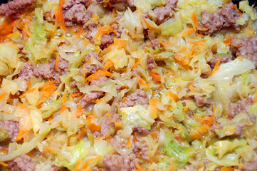 Background from stewed cabbage with meat and carrots