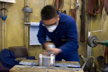 Polishing metal in workshop