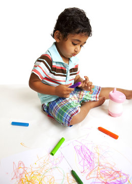 Toddler Playing with Crayons on White