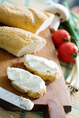 Bread slices with cream cheese in the kitchen