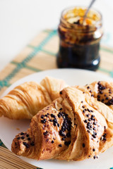 Chocolate croissant with gem on plate