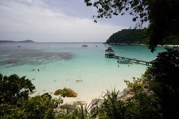 White sand beach with jetty, turquoise water, green frame