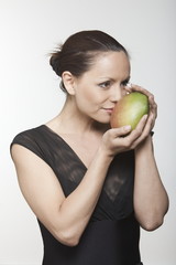 woman holding mango