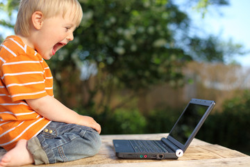 Excited boy with laptop