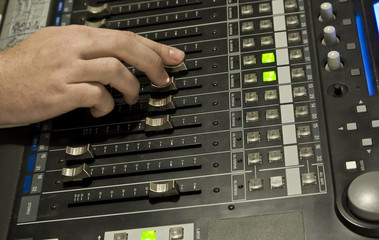 Obraz premium Sound producer behind work. Management of mixer