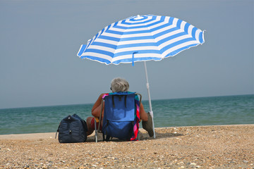 Relaxing on the beach under an unbrella