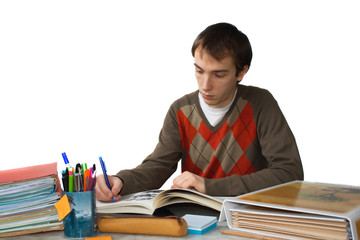Student writing at table