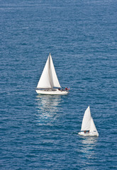 Two White Sailboats on Blue