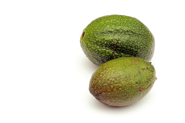 two avocado on white