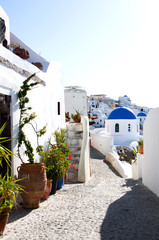 street scene with blue dome church and cyclades architecture san