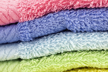 Close up shot of Pink, blue, yellow and green towels