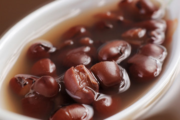 red bean soup close up in ceramic spoon