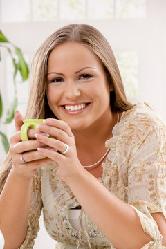 Happy woman holding tea cup