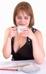 Young woman with a cup of coffee on a breakfast..