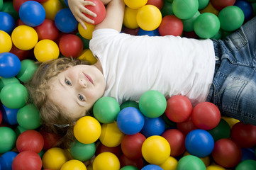 Fototapeta na wymiar Little girl in colorful balls