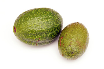 two avocados from above over white