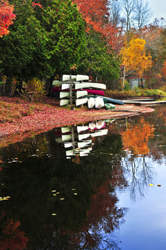 Fall forest reflections with canoes