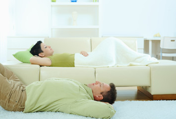 Couple sleeping at home