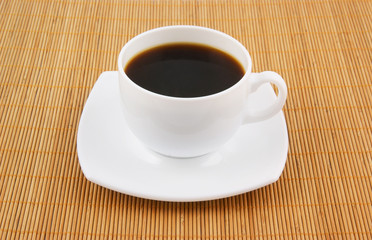 White cup of coffee on wooden background