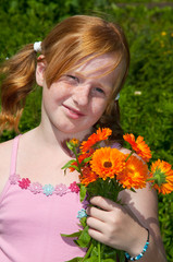 Naklejka premium Girl is plucking marigolds