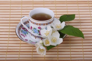 Cup of tea with jasmine flowers