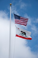 USA and California flags on white pole