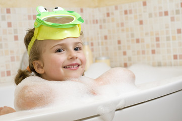 Cute girl playing in foam
