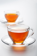 two cups of tea over white background