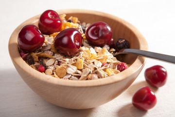 muesli with cherry in wooden bowl