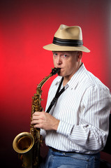 Saxophone Player Isolated on Red