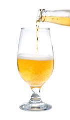 pouring beer from a bottle into a glass, isolated on white