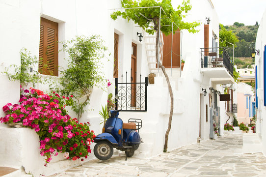 Fototapeta street scene motor scooter greek cyclades islands architecture