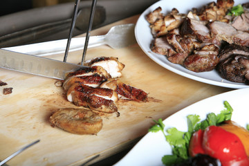 Grilled steak being cut on a cutting board