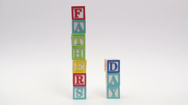 Wooden alphabet blocks spell out FATHER'S DAY
