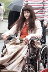 young woman on walk in an invalid carriage