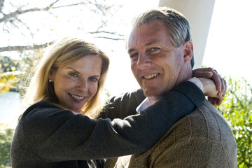 Fototapeta premium Portrait of smiling mature couple embracing outdoors