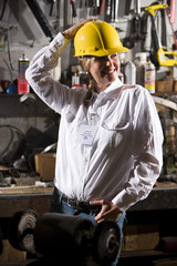 Female worker standing in office maintenance room