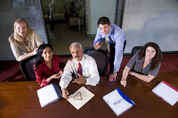 Multiethnic businesspeople sitting at boardroom table
