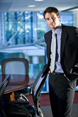 Young businessman standing in boardroom