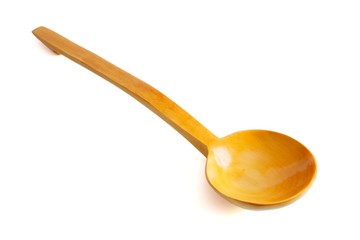 Yellow wooden spoon on white background
