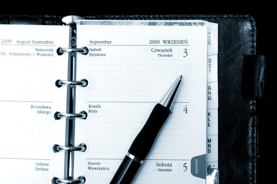 notebook, calendar and pen