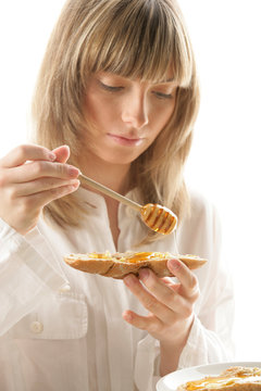 Young Woman With Honey And Bread