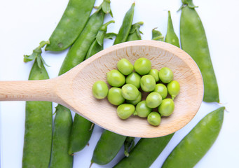 Grains of green beans in wooden spoon