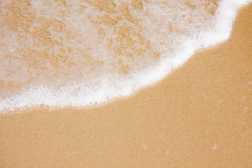 Wave on clear sand beach