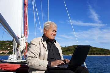 Working Busineseman on the sailboat.