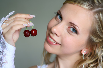 Beautiful bride with sweet cherry