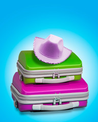 Two colouyrful suitcases with hat