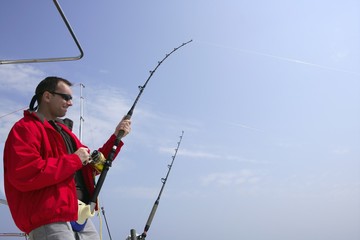 Fisherman fishing on boat big game tuna